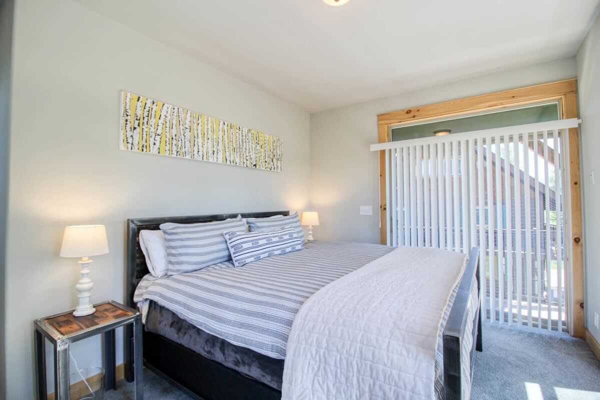 【Primary Suite】King bed upstairs — slide the door open and sleep to the river