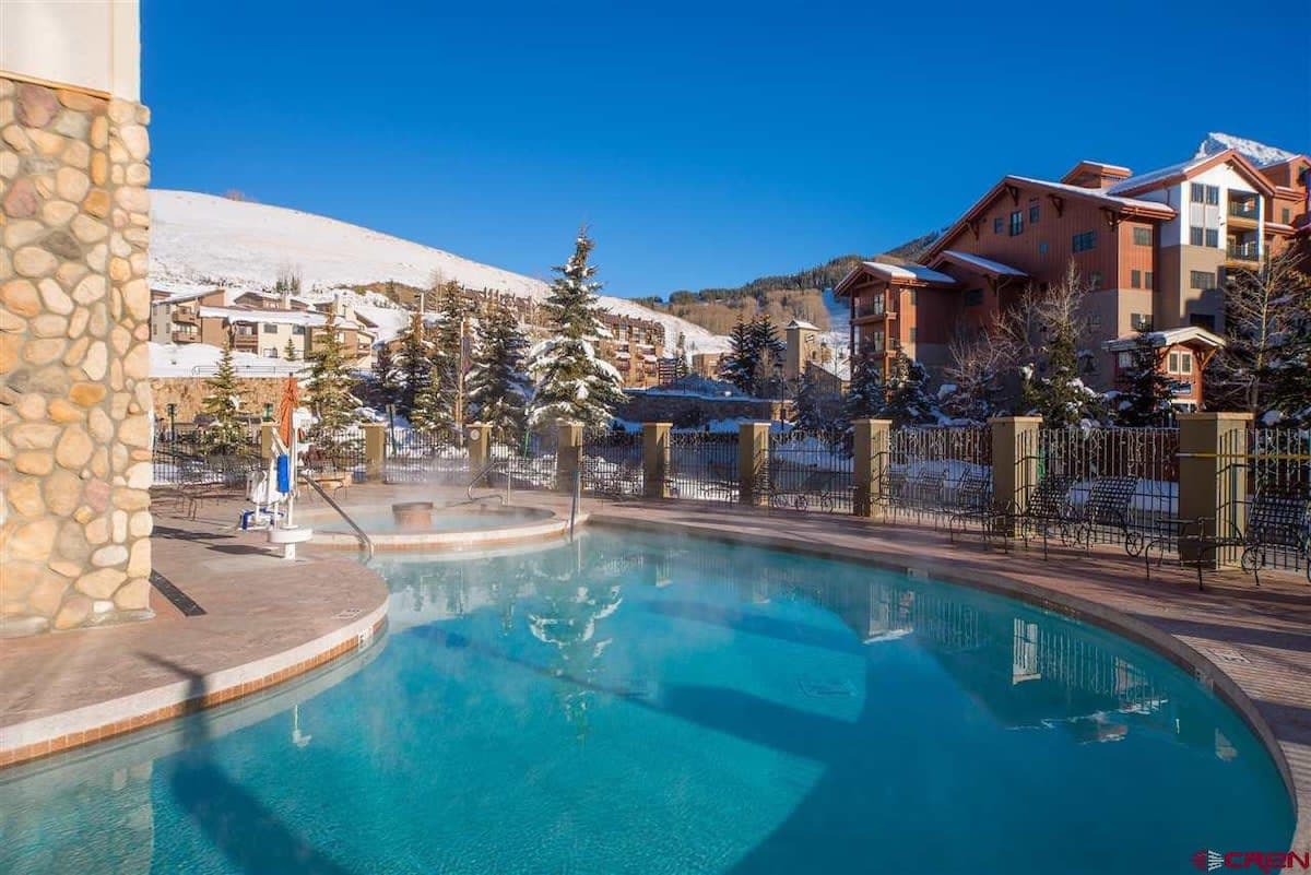 【Hot Tub & Pool】Steam off the hot tub with Mt. Crested Butte at the rail — open year-round through the building.