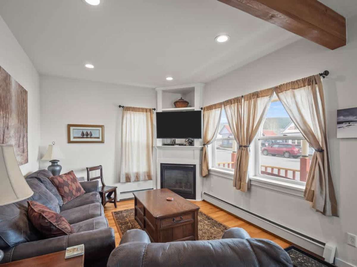 【Living Room】 Gas fireplace crackles on cool Leadville nights — Victorian bones, updated comfort.