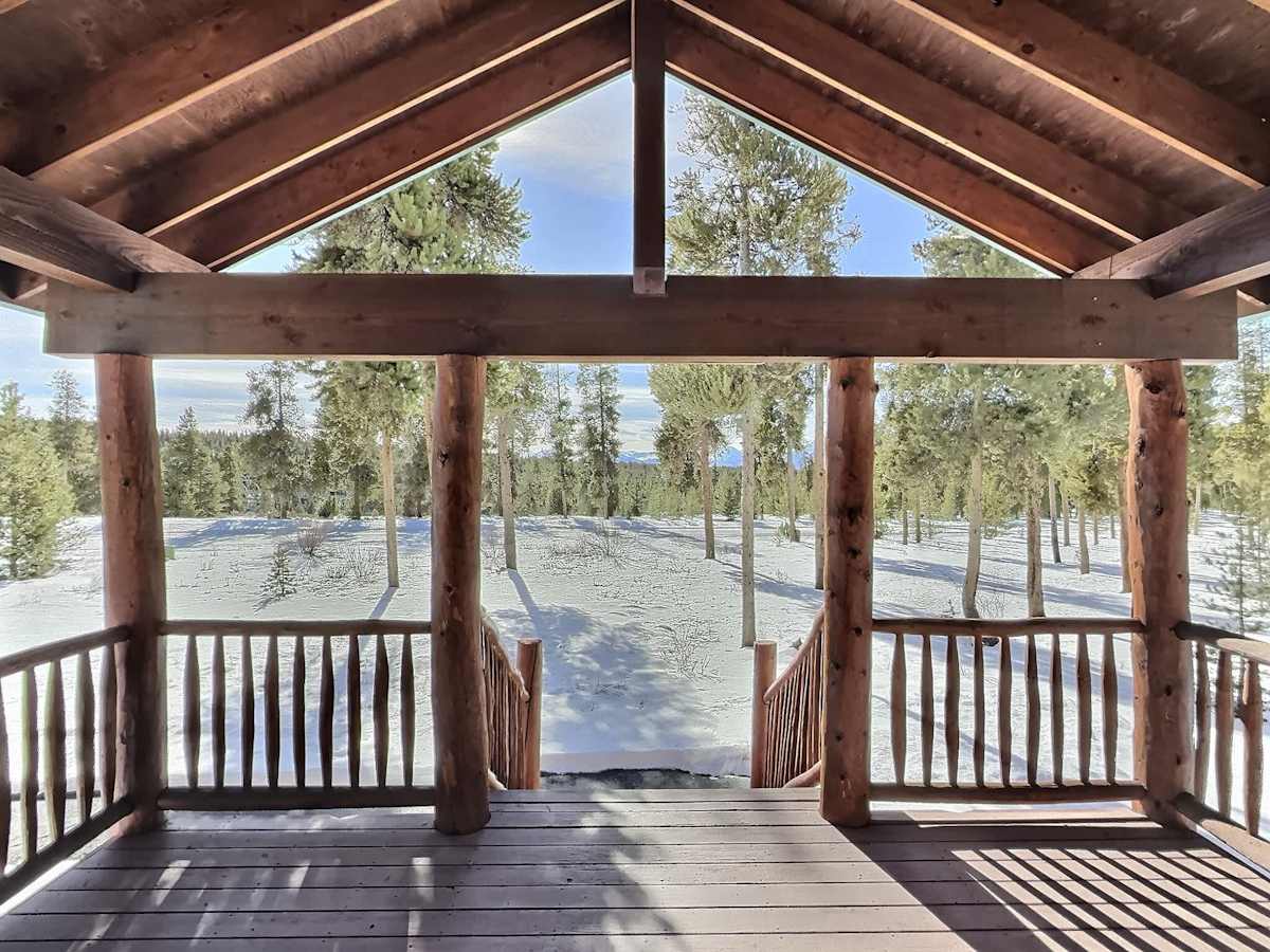 【Deck】Covered porch over the lodgepole pines — your morning coffee spot
