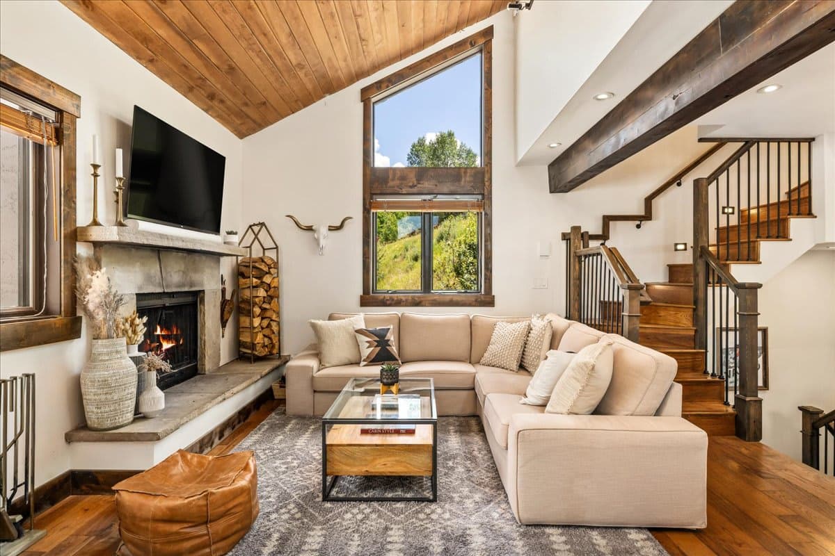 Bright living room featuring a wood-burning fireplace, Smart TV, and mountain views.