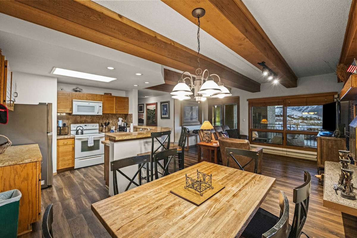 【Living Room】Woodburning fireplace + down-valley views — home base after a ski day