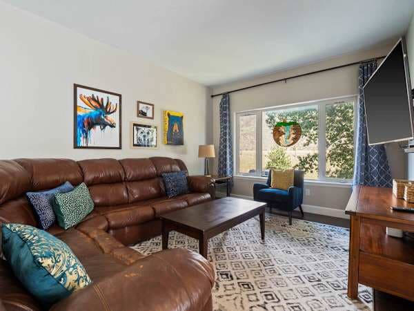 【Living Room】Fireplace and sectional, opening to the balcony