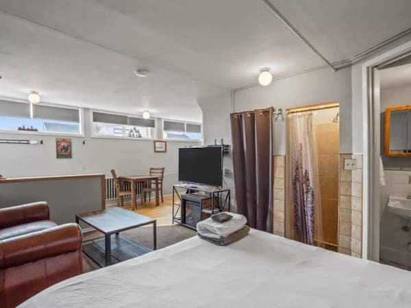 a queen bed and a dining are