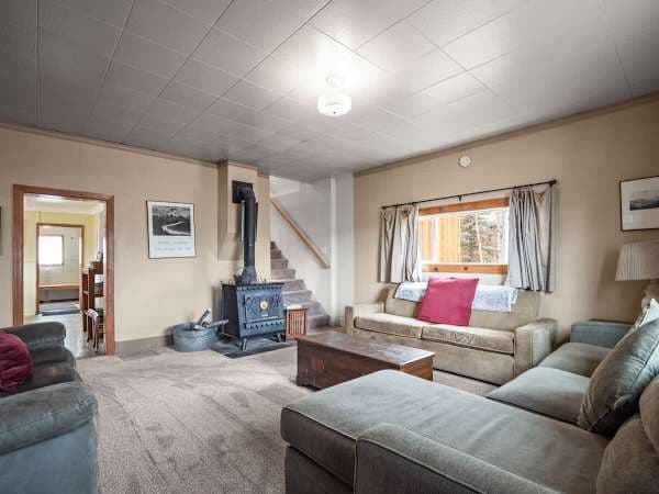 【Living Room】Open to the dining area — the group hangs together