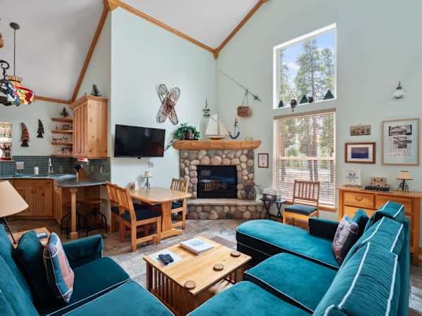 【Living Room — wide】Open angle showing flow into kitchen and dining area — small but well-laid-out for 4.