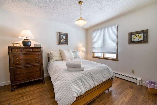 【Bedroom 1 — Queen】Soft linens, full closet, blackout curtains for sleep-in mornings post-ski day.
