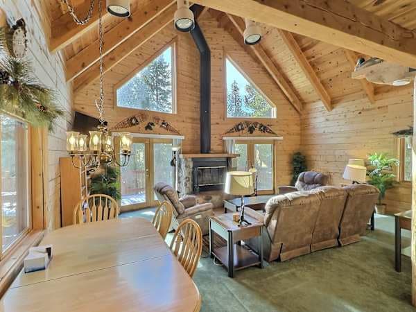 【Great Room】Vaulted log ceilings and walls of glass — space for all six to spread out