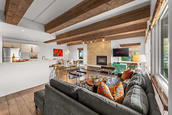【Living Room】Stone fireplace lit by 5 p.m. — the spot everyone gravitates to post-ski