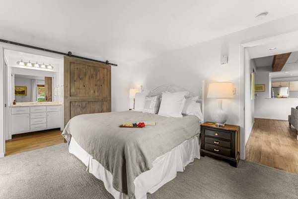 【Primary Bedroom】King bed + ensuite bath — blackout shades for sleeping in after late runs