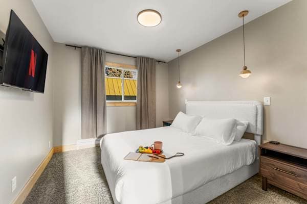 【Bedroom 2】Queen, blackout curtains, pendant light — the quiet side for deep sleep
