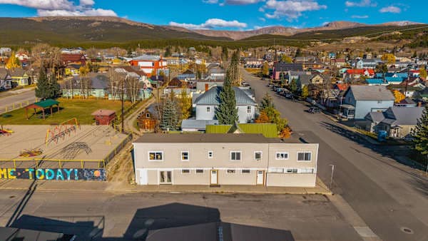【Aerial】Main Street is two blocks off — mountains fill every window and horizon