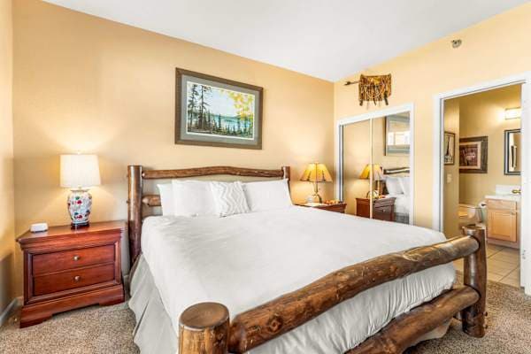 【Primary Bedroom】King bed with en-suite bathroom — the quiet end of the condo