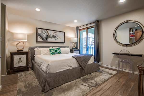 【Primary Bedroom — King Ensuite】Room-darkening shades + balcony slider for a dead-quiet post-ski sleep