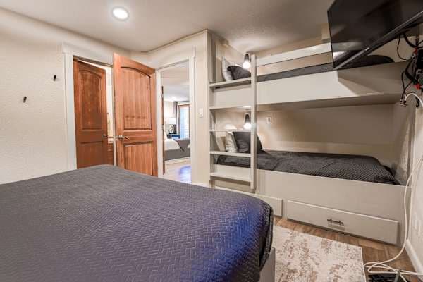 【Second Bedroom — King + Bunks】Parents get the King, kids claim the built-in twin bunks