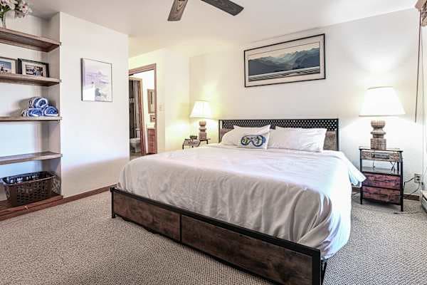 【Bedroom 1 — Balcony Door】King w/ private balcony access — quiet end of the condo