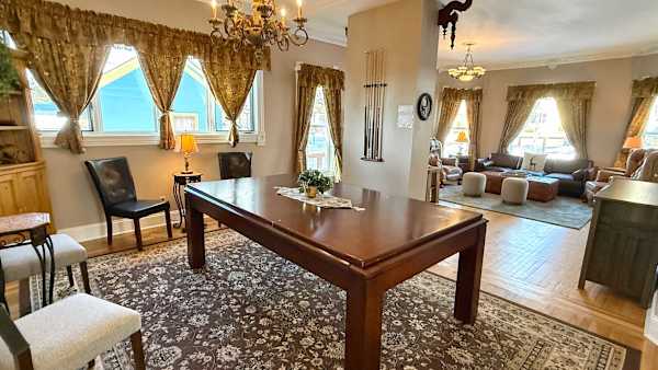 【Billiard Room】Full-size table under the chandelier — the nightly rematch